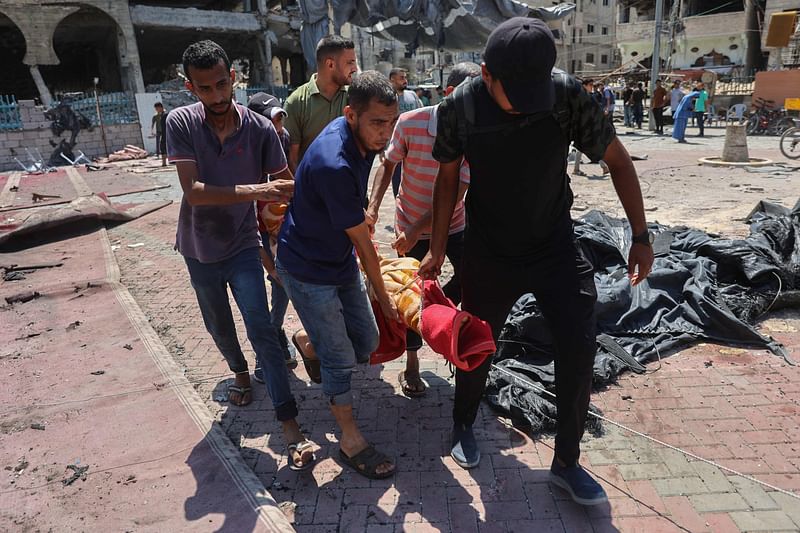 Palestinians carry the bodies of relatives killed during an Israeli strike which hit a makeshift prayer hall at al-Shati refugee camp west of Gaza City on July 13, 2024 amid the ongoing conflict between Israel and the militant Hamas group in Gaza